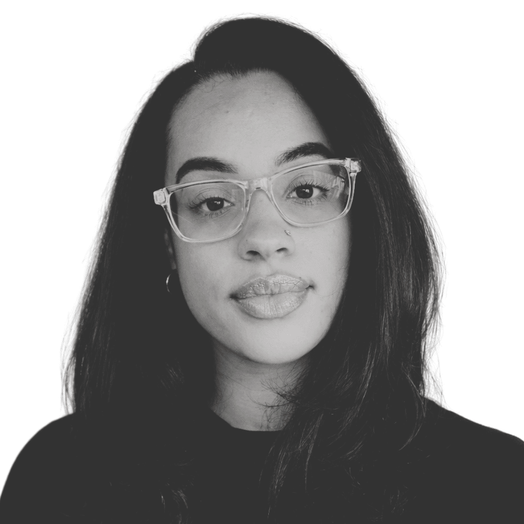 a woman wearing glasses and smiling at the camera