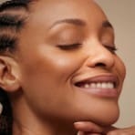 a close up of a girl smiling for the camera