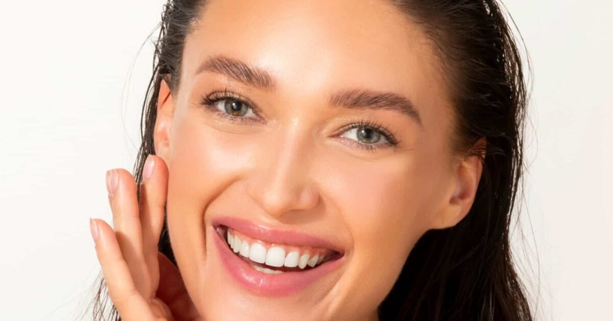A smiling woman with fresh, bright skin because she had a HydraFacial.