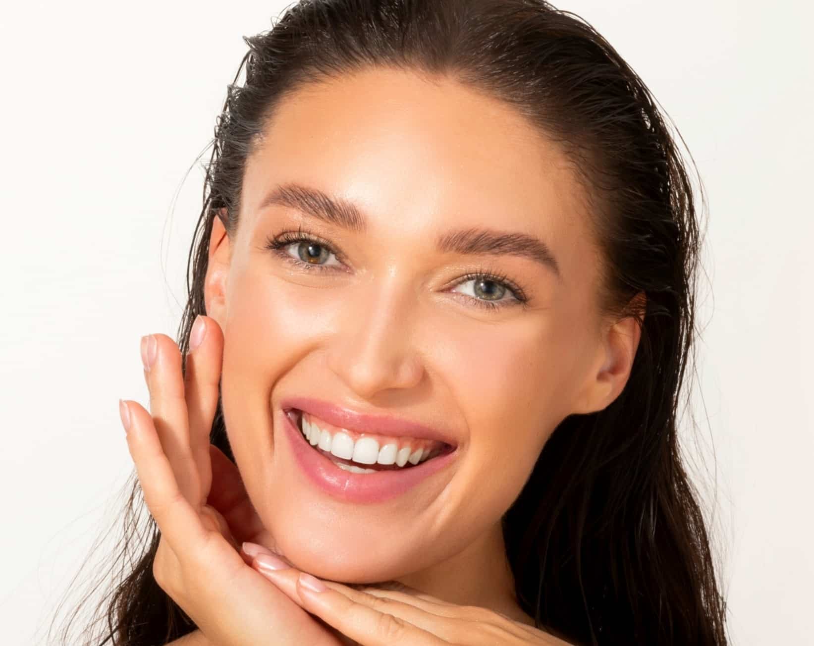 A smiling woman with fresh, bright skin because she had a HydraFacial.