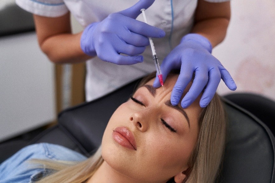 A woman receiving a treatment at an aesthetic spa